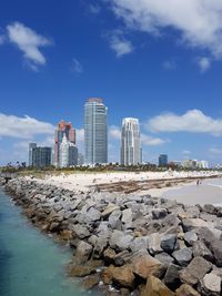 View of cityscape against cloudy sky