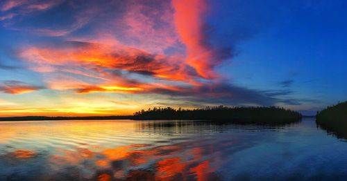 Scenic view of lake against romantic sky at sunset