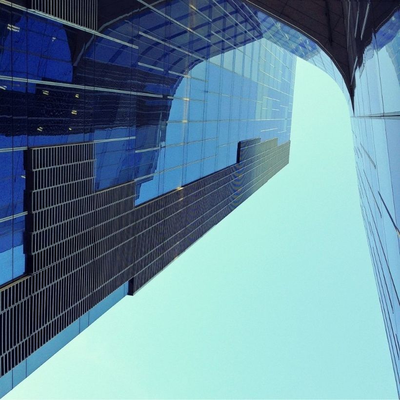 architecture, built structure, building exterior, blue, low angle view, modern, clear sky, reflection, glass - material, office building, city, building, tower, tall - high, day, skyscraper, sky, window, sunlight, no people