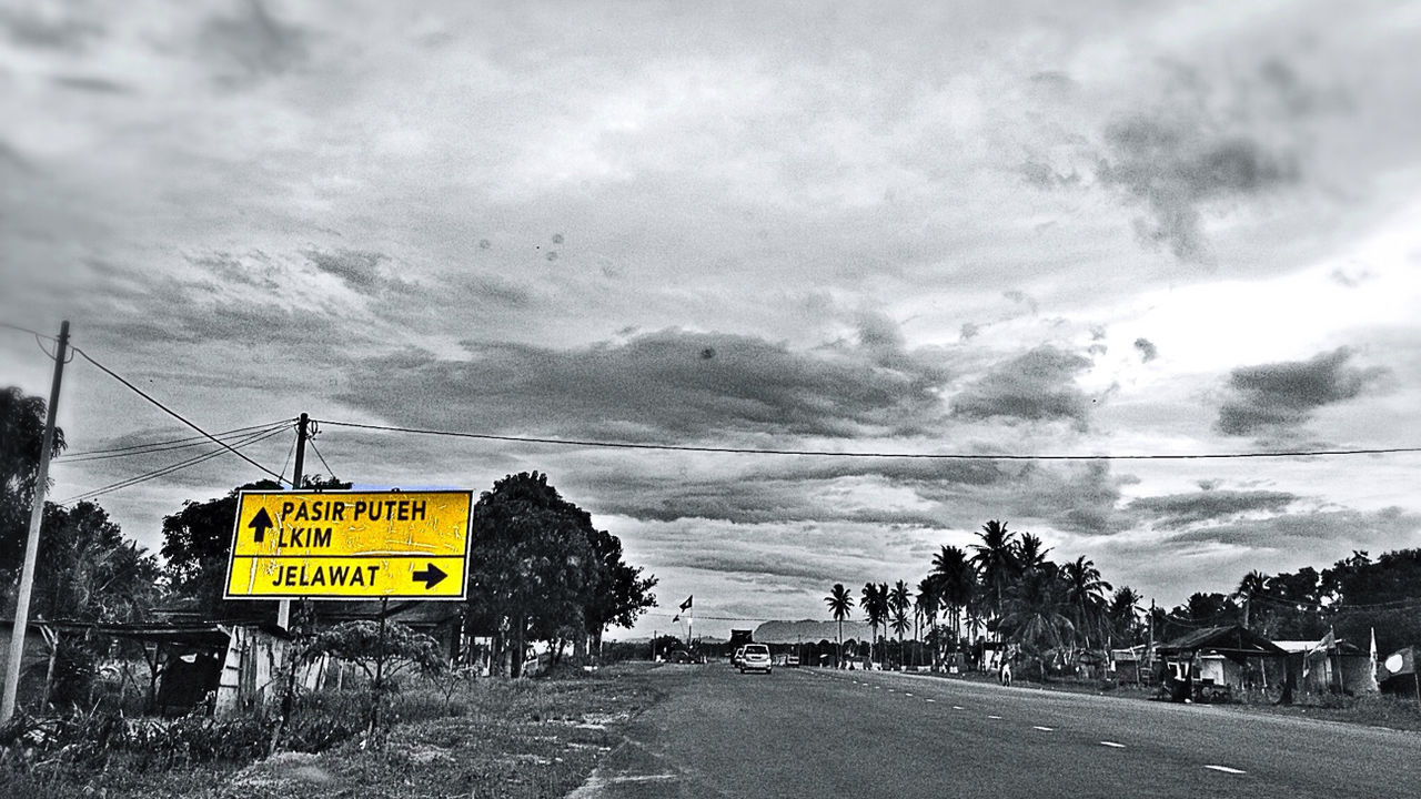 transportation, sky, road, cloud - sky, road sign, text, western script, communication, information sign, cloudy, the way forward, guidance, yellow, land vehicle, street, mountain, cloud, sign, road marking, car