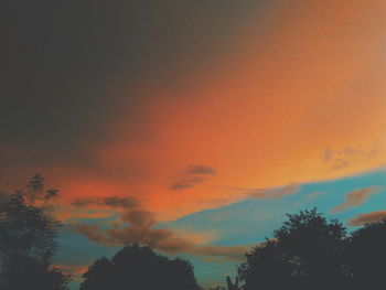 Low angle view of silhouette trees against sky during sunset