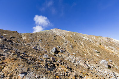 Low angle view of mountain against blue sky