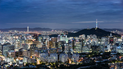 Cityscape against cloudy sky at dusk