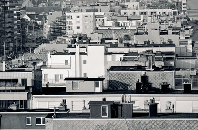 Looking from above on roof tops at oostende coast promenade in black and white showing architecture 