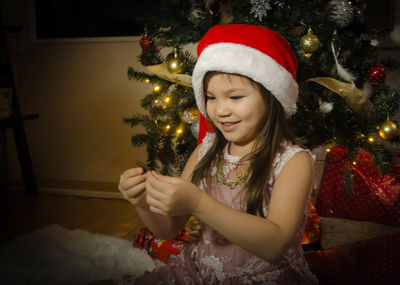 Woman holding christmas tree at home