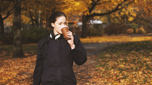 Young woman drinking coffee to go while on the move