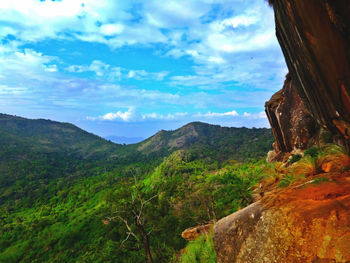 Scenic view of mountains against cloudy sky