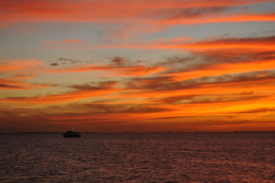 Scenic view of sea against orange sky