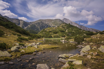 Scenic view of lake and mountains against sky