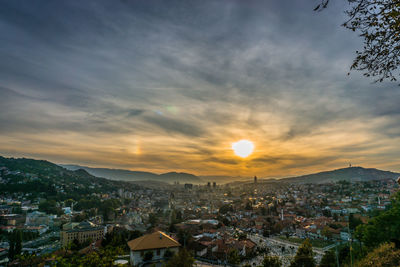 High angle shot of townscape against sky at sunset