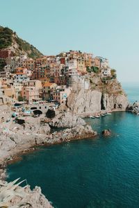 Townscape by sea against clear sky