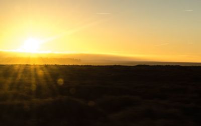 Scenic view of landscape against sky during sunset