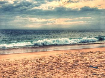 Scenic view of beach against sky during sunset