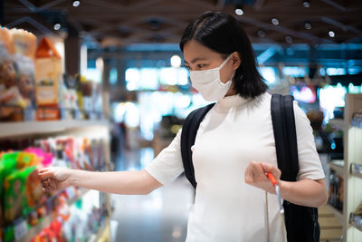 Midsection of woman standing in store