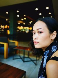 Portrait of beautiful young woman looking away