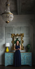 Portrait of woman standing against wall