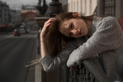 Young woman sleeping on street in city