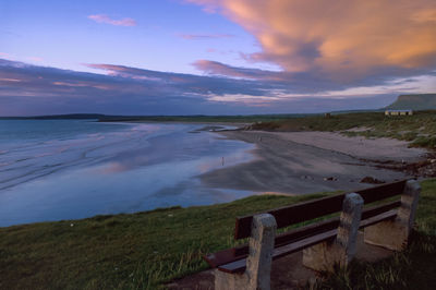 People on the beach and in the sea at rosses point, county sligo, ireland