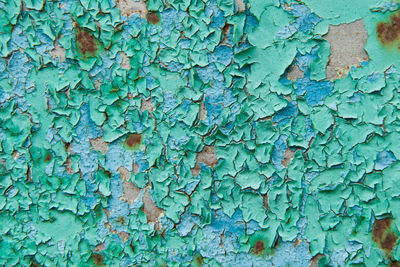 Closeup of old peeling green paint on a metal surface. abstract industrial vintage pattern texture