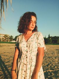 Woman looking down while standing outdoors