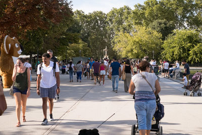 Rear view of people on street in city