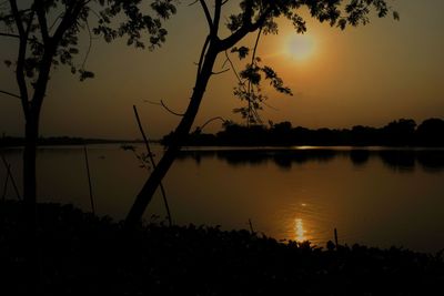 Scenic view of lake against sky during sunset