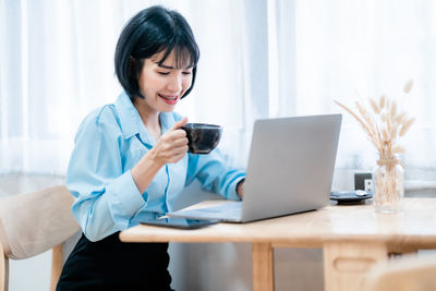 Portrait of young businesswoman working on table