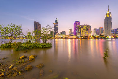 Reflection of buildings in city at waterfront