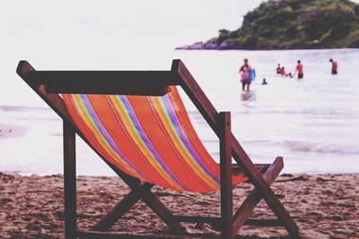 Lounge chair on shore at beach