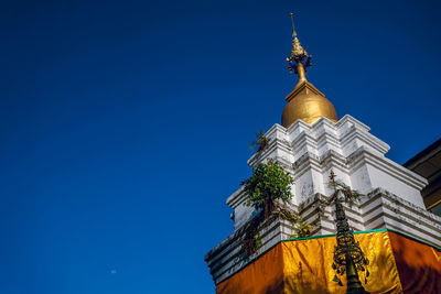 Low angle view of traditional building against clear blue sky