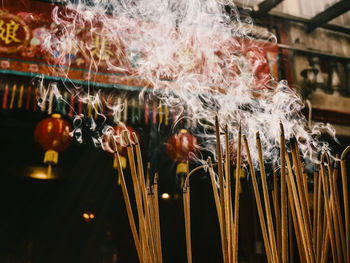 Close-up of illuminated lighting equipment hanging outdoors