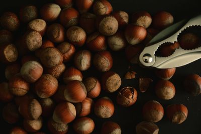 Full frame shot of hazelnuts with nutcracker