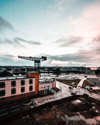 High angle view of construction site by buildings against sky