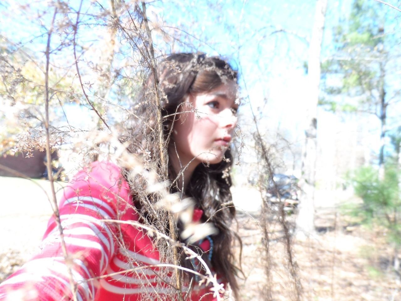 person, looking at camera, lifestyles, portrait, young adult, young women, leisure activity, front view, long hair, casual clothing, headshot, tree, focus on foreground, winter, smiling, season, day