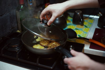 Midsection of person preparing food in kitchen