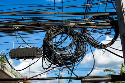 Low angle view of cables against sky