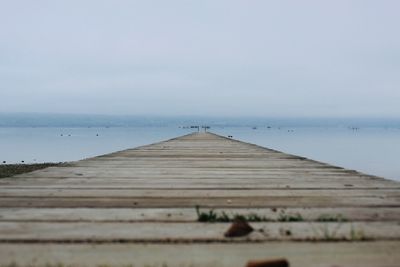 Pier over sea against sky