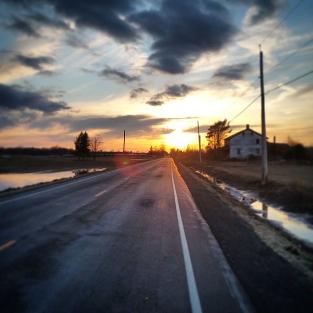 sunset, the way forward, sky, transportation, diminishing perspective, cloud - sky, road, vanishing point, orange color, cloudy, cloud, sun, weather, dramatic sky, street, road marking, nature, outdoors, empty, no people