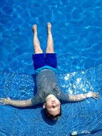 High angle view of boy swimming in pool