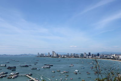 High angle view of city by sea against sky