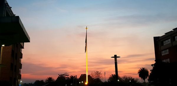 Low angle view of street lights against sky during sunset