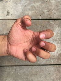 Close-up of man hand gesturing against wall