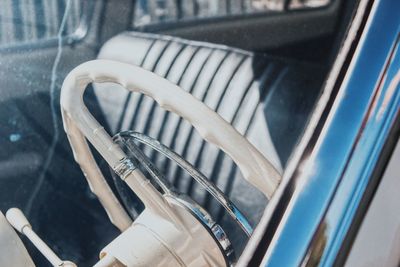 Close-up of steering wheel seen through car windshield