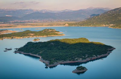 Scenic view of lake and mountains against sky