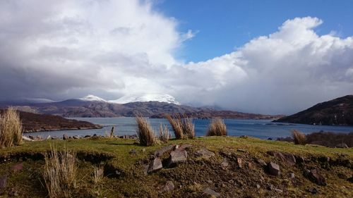 Scenic view of mountains against cloudy sky