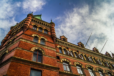 Low angle view of building against cloudy sky