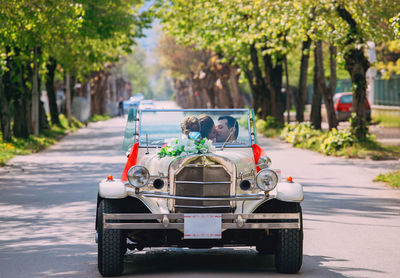 View of people riding motorcycle on road