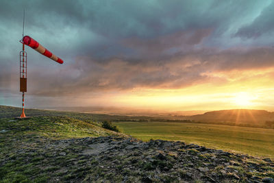 Scenic view of field against sky during sunset