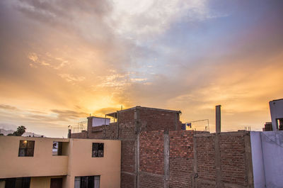 Low angle view of buildings against sky during sunset