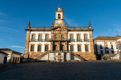 Low angle view of historical building against blue sky